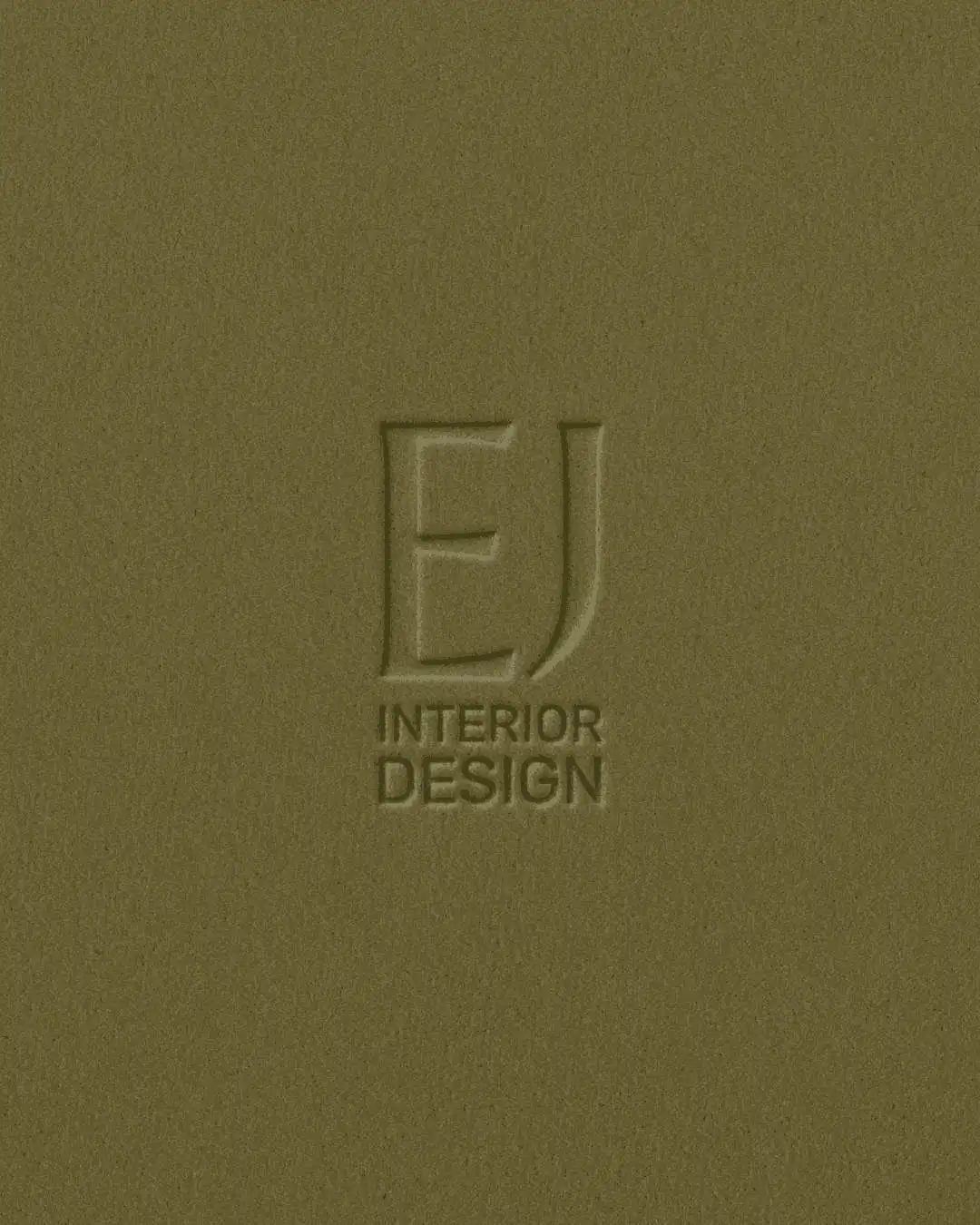 The EJ Interior Design mark debossed into olive paper