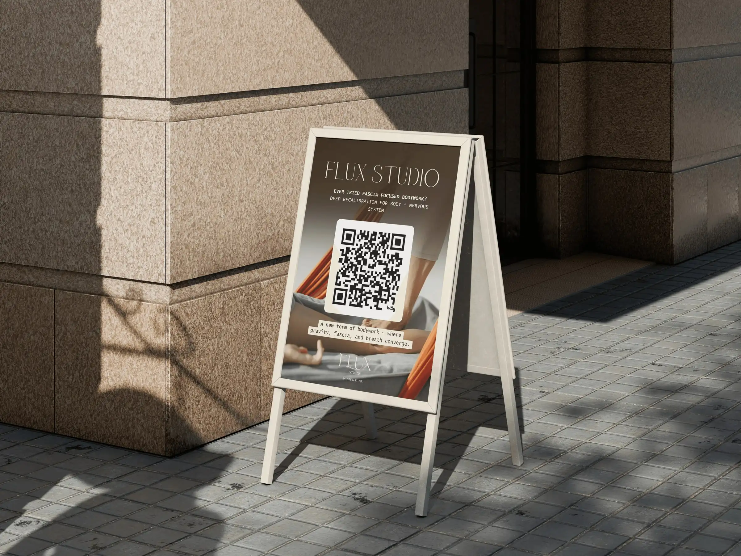 A Flux Studio sandwich board on a city sidewalk, asking “Ever tried fascia-focused bodywork?” above a QR code