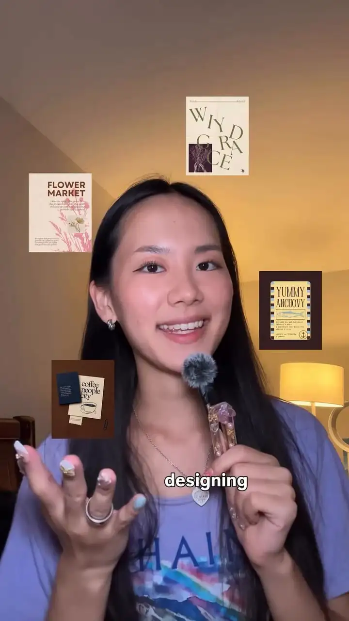 Alena talking to camera, surrounded by finished posters including a Flower Market design
