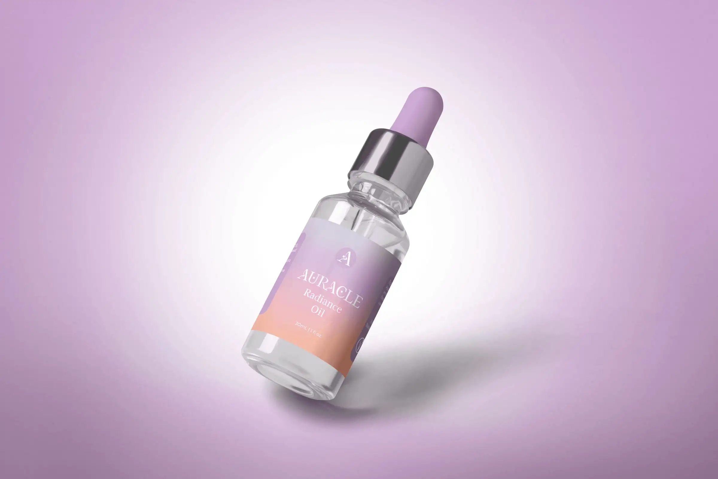Auracle Radiance Oil: a dropper bottle with a lilac-to-peach gradient label